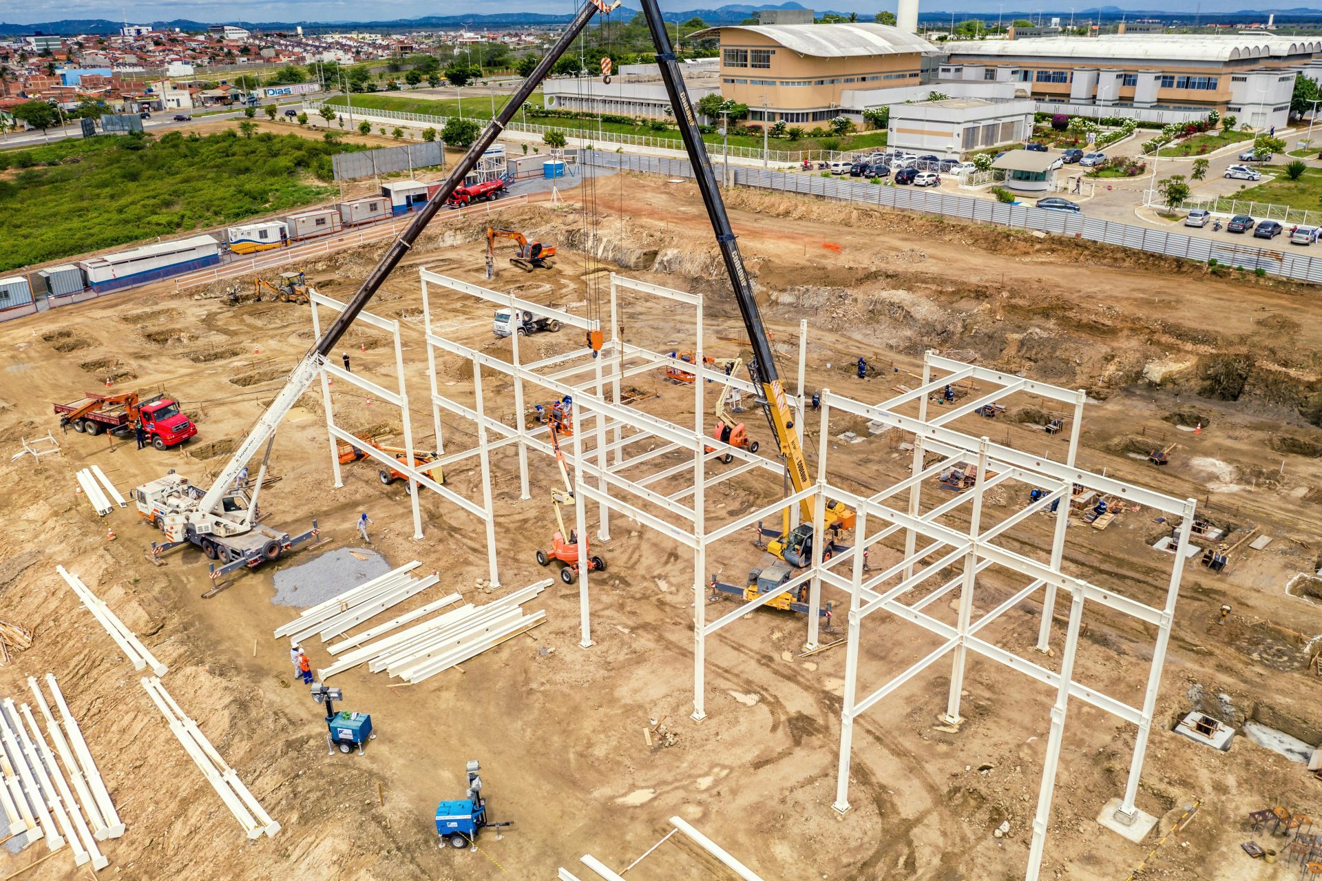 Aerial shot of an active construction site with cranes and machinery in Malvinas, Brazil.